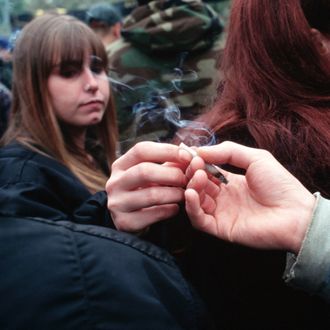04 May 1996, New York City, New York State, USA --- A woman passes a joint at Hemp Fest '96/Cures Not Wars, a rally to legalize pot.