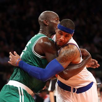 Carmelo Anthony #7 of the New York Knicks and Kevin Garnett #5 of the Boston Celtics get into an altercation at Madison Square Garden on January 7, 2013 in New York City.