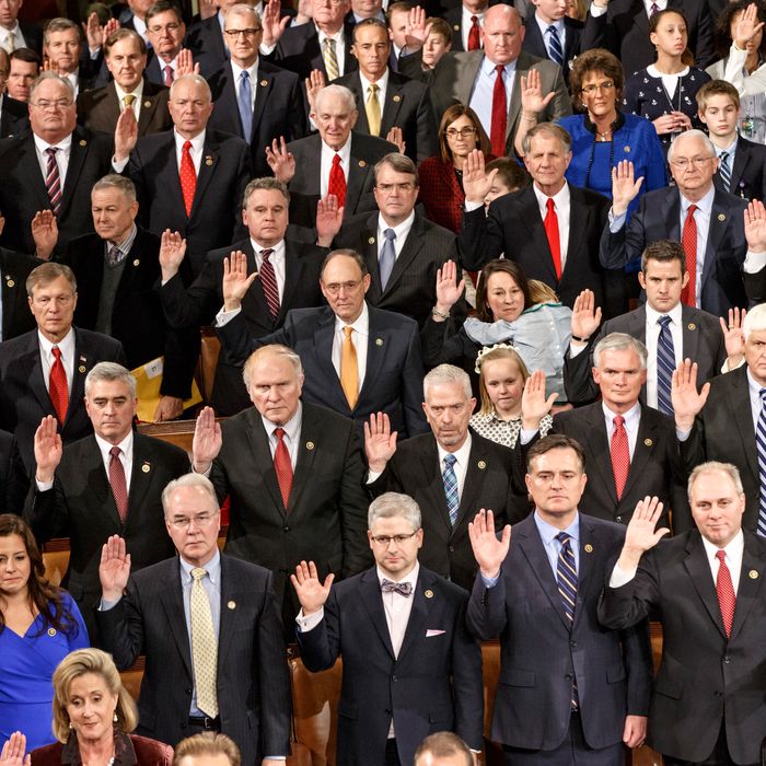Members of the House of Representatives on the GOP side raise their hands for the oath of office at the opening session of the 114th Congress, Tuesday, Jan. 6, 2015, on Capitol Hill in Washington. House Speaker John Boehner of Ohio, won a third term despite a tea party-backed effort to unseat him. 