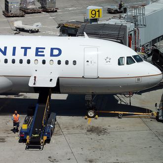 SAN FRANCISCO, CA - JULY 26: Ground crews work on a United Airlines plane at San Francisco International Airport on July 26, 2012 in San Francisco, California. United Continental Holdings reported a 37 percent second quarter loss with earnings of $339 million or 89 cents a share compared to $538 million or $1.39 a share one year ago. (Photo by Justin Sullivan/Getty Images)