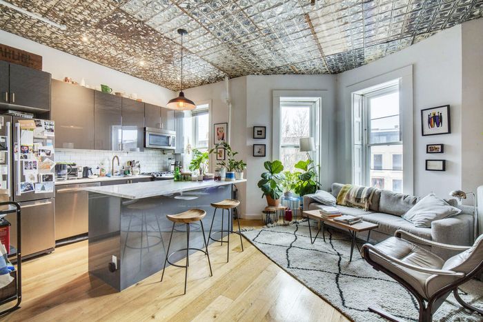 Living room and kitchen with tin ceilings.