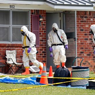 Federal agents wearing hazardous material suits and breathing apparatus exit the home and possessions in the West Hills Subdivision house of Paul Kevin Curtis in Corinth, Miss., Friday, April 19, 2013. Curtis is in custody under the suspicion of sending letters covered in ricin to the U.S. President Barack Obama and U.S. Sen. Roger Wicker, R-Miss. (AP Photo/Rogelio V. Solis)