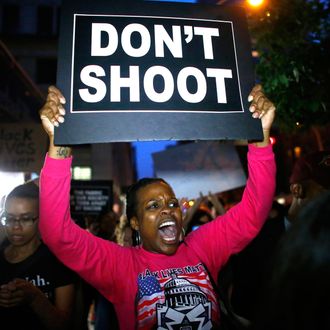 A woman holds a banner during a protest in support of the Black lives matter movement in New York on July 09, 2016. 