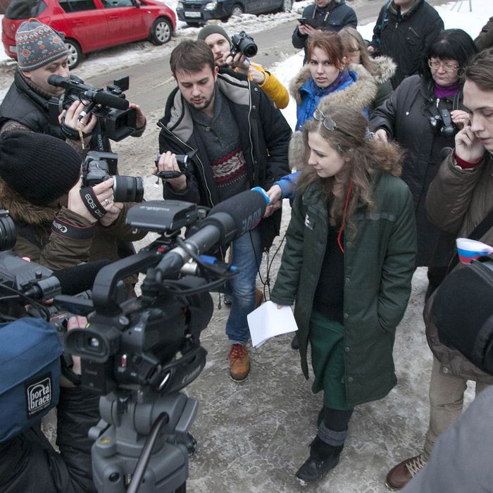 Maria Alyokhina, one of the jailed members of anti-Kremlin punk band Pussy Riot, is surrounded by journalists as she walks after beeing freed in Nizhny Novgorod on December 23, 2013. Alyokhina, who was freed from prison under a Kremlin-backed amnesty slammed the measure as a mere publicity stunt and said that she would have preferred to remain in prison.