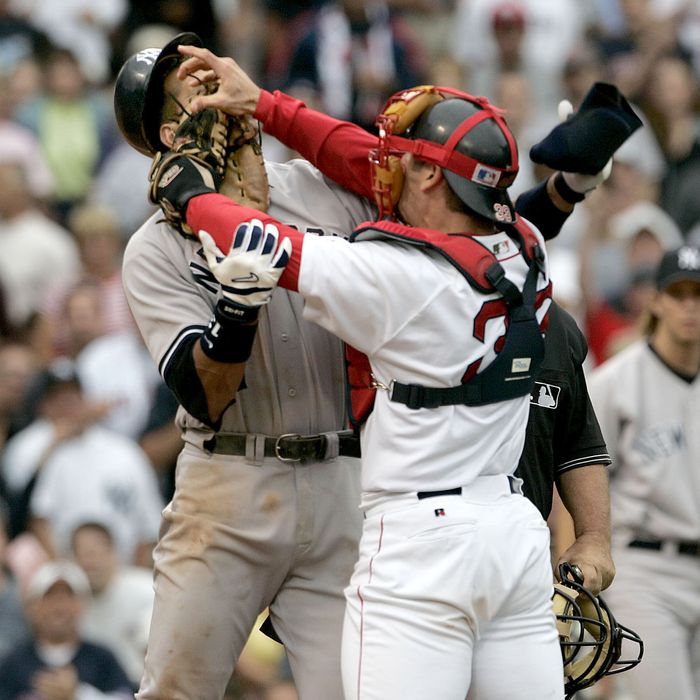 Boston Red Sox catcher Jason Varitek, right, strikes New York Yankees batte...