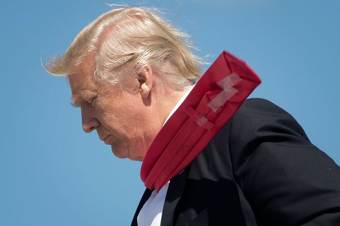 Wind blows President Donald Trump's tie, revealing Scotch tape on the back, as he arrives at Orlando International Airport on March 3, 2017.