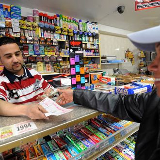 Clerk Abdulwali Mohamed Osaim (L) sells Mega Millions lottery tickets at a convenience store on the east side of Manhattan March 30, 2012 in New York. The jackpot is at a record level because no one has matched the magic five numbers and Mega Ball since January 24 -- a full 18 drawings with no winner. Given the pace of the ticket buying, the jackpot will go even higher. A lottery spokesman reportedly has announced that the jackpot has risen to $640 million.