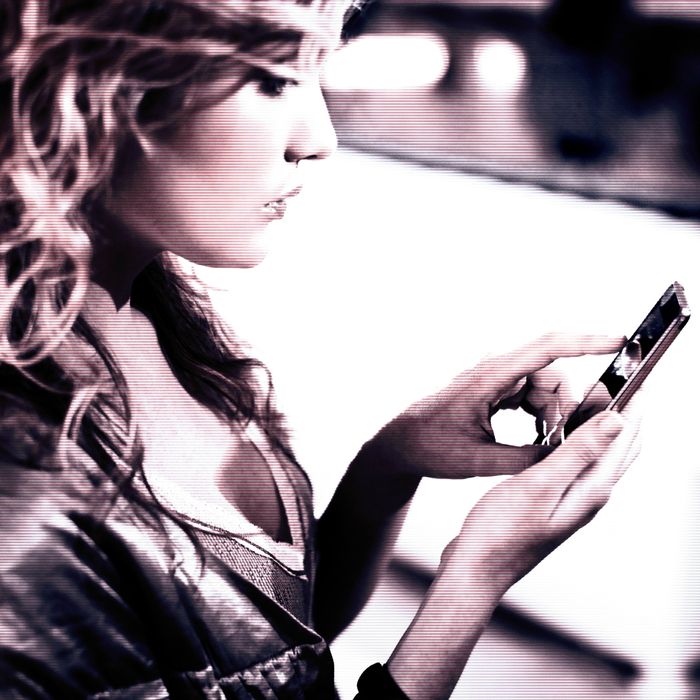 Woman text messaging on cell phone