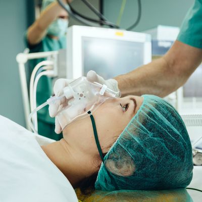 Patient with breathing mask on operating table