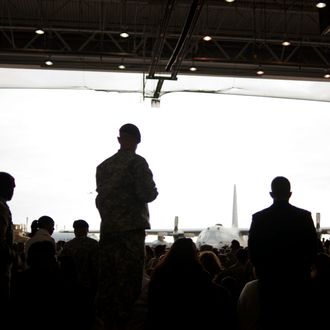 FORT BRAGG, NC - DECEMBER 14: Troops wait for the arrival of President Barack Obama and the First Lady Michelle Obama during a Presidential visit to honor troops returning home from Iraq on December 14, 2011 to Fort Bragg, N.C. America is ending its war in Iraq and all U.S. troops are scheduled to be removed from Iraq by December 31.(Photo by Davis Turner/Getty Images)