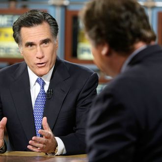 WASHINGTON - DECEMBER 16: (AFP OUT) Republican U.S. presidential hopeful and former Massachusetts Governor Mitt Romney (L) speaks as he is interviewed by moderator Tim Russert during a taping of 