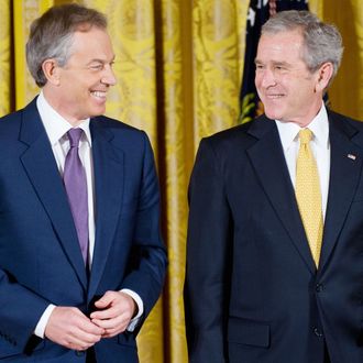 US President George W. Bush smiles along