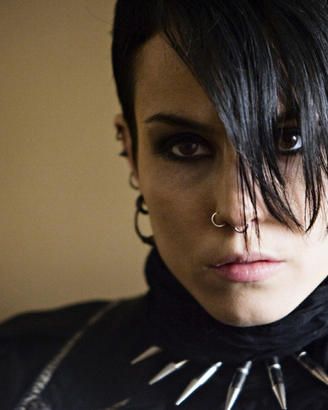 Noomi Rapace smiling for the camera as Lisbeth Salander.