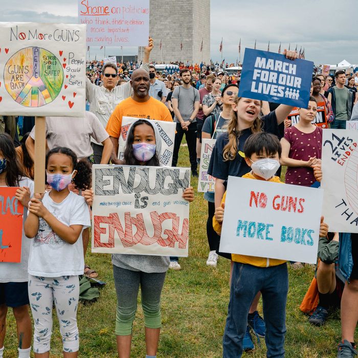 Demonstrators hold signs at the second March for our Lives rally.