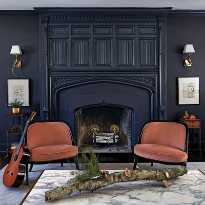 The living room’s moody palette helped make the couple’s art collection pop.
