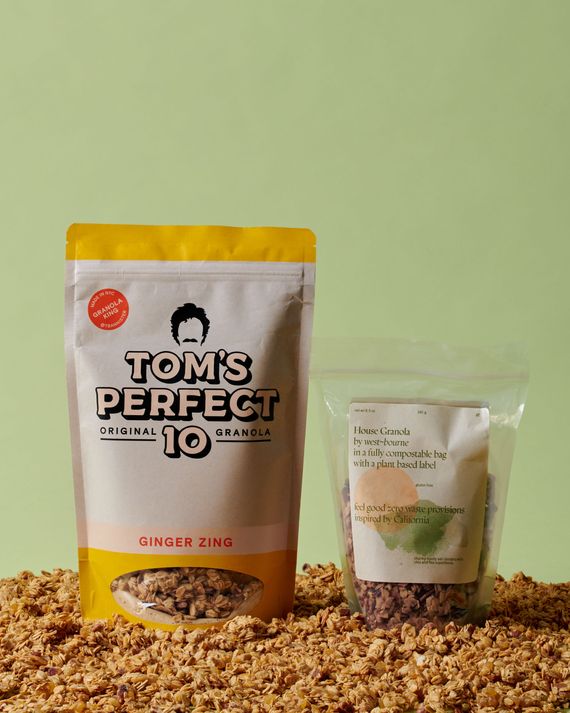 A large packet of Tom's Perfect 10 Ginger Zing granola next to a smaller packet of granola from West~bourne