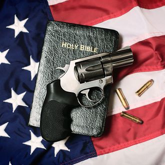 Gun and Bible on American Flag