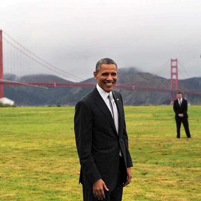US President Barack Obama smiles before boarding Marine One helicopter from a field overlooking the iconic golden gate bridge in San Francisco, California, on April 4, 2013. Obama is in California to attend two DCCC fund rising events.