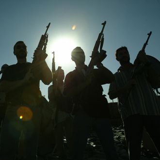 Members of a private security company pose on the rooftop of a house in Baghdad, 18 September 2007. Iraq declared today it will review the operations of all security firms working in the war-ravaged country following a deadly shootout involving private US contractor Blackwater. AFP PHOTO/PATRICK BAZ (Photo credit should read PATRICK BAZ/AFP/Getty Images)