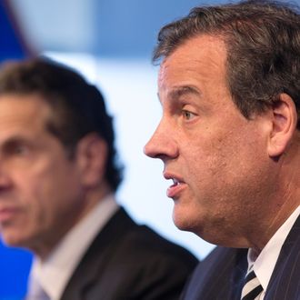 New York Governor Andrew Cuomo, left, listens as New Jersey Governor Chris Christie talks at a news conference, Friday, Oct. 24, 2014 in New York. The governors announced a mandatory quarantine for people returning to the United States through airports in New York and New Jersey who are deemed 