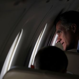  Republican presidential candidate, former Massachusetts Gov. Mitt Romney looks out the window of his campaign plane trying to locate his house after taking off from San Diego International Airport enroute to Colorado on May 28, 2012. Romney spoke at a Memorial Day tribute with U.S. Sen John McCain before heading to Colorado. 