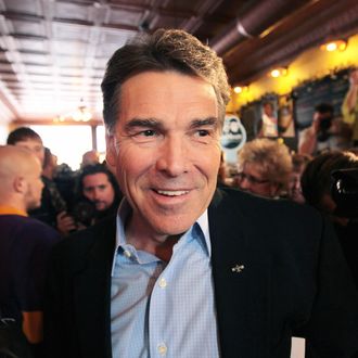 CHEROKEE, IA - DECEMBER 16: Republican presidential candidate Texas Governor Rick Perry arrives at the Copper Cup coffee shop for a campaign stop on December 16, 2011 in Cherokee, Iowa. Perry and the other GOP contenders are in the final stretch of campaigning in Iowa, where the caucus on January 3, 2012 is the first test the candidates must face to become the Republican presidential nominee. (Photo by Scott Olson/Getty Images)