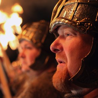 Men dressed as Vikings lead the torchlight procession