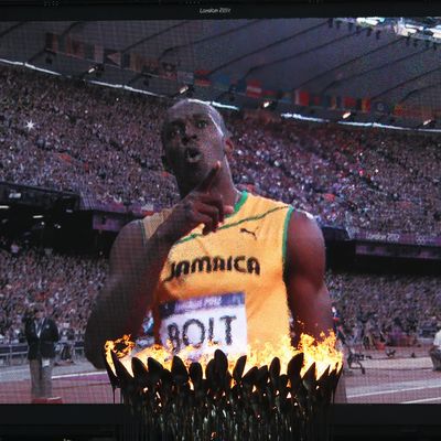The Olympic Cauldron burns as Usain Bolt of Jamaica is seen afer competing in the Men's 200m Semifinals on Day 12 of the London 2012 Olympic Games at Olympic Stadium on August 8, 2012 in London, England.