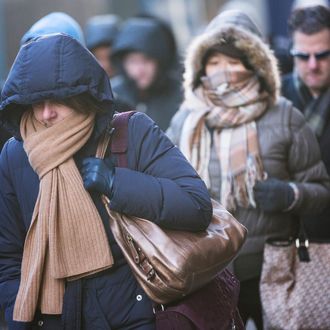 NEW YORK, NY - JANUARY 07: Morning commuters bundle up against the cold on the morning of January 7, 2014 in New York, United States. A polar vortex has descended on much of North America, coming down from the Arctic, bringing record freezing temperatures across much of the country. (Photo by Andrew Burton/Getty Images)