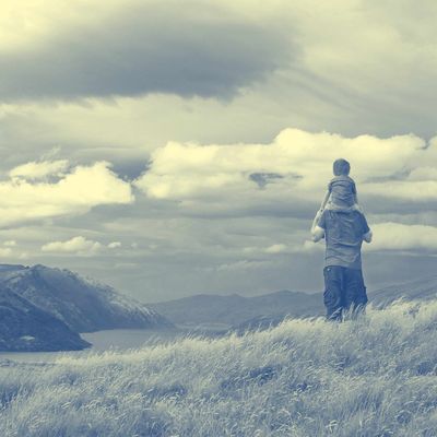 Queenstown, South Island, New Zealand --- Young boy sits upon his fathers shoulders.