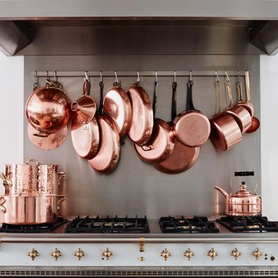 Copper pots hanging in the French kitchen of the Cook's Atelier in Paris — the Strategist reviews all the essentials needed to re-create a French kitchen.