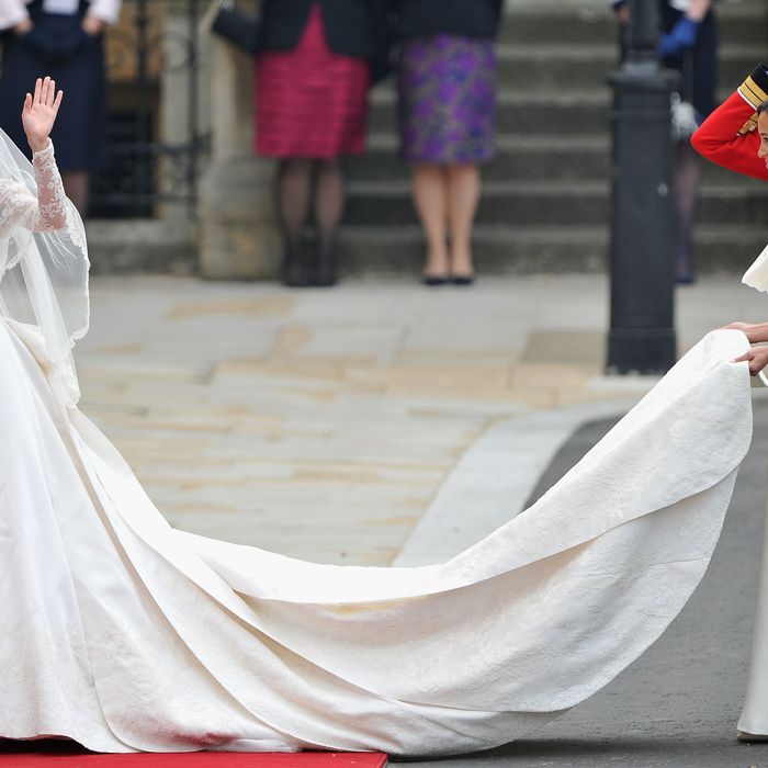 Kate in an Alexander McQueen dress by Sarah Burton, with her sister, Pippa, holding her train.