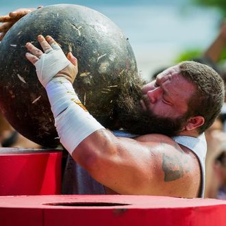 Robert Oberst of USA competes at the Atlas Stones event during the World's Strongest Man competition at Yalong Bay Cultural Square on August 24, 2013 in Hainan Island, China. 