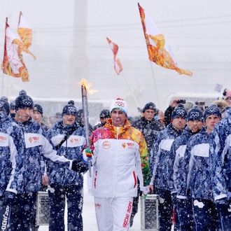 A torchbearer carries an Olympic torch during the Sochi 2014 Winter Olympic torch relay in the southern Russian city of Stavropol, on January 23, 2014. 