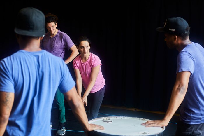 Danya Taymor (center) with actors in rehearsal.