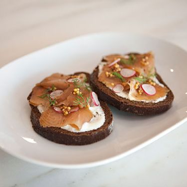 with house creme fraiche, pickled mustard seeds, shaved radish on pumpernickel