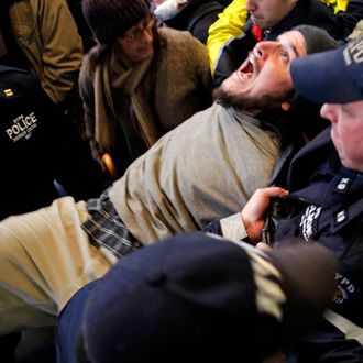 An Occupy Wall Street protester yells as he is arrested by the police after blocking an intersection near The New York Stock Exchange in New York, Thursday, Nov. 17, 2011. Two days after the encampment that sparked the global Occupy protest movement was cleared by authorities, demonstrators marched through New York's financial district and promised a national day of action with mass gatherings in other cities. (AP Photo/Seth Wenig)