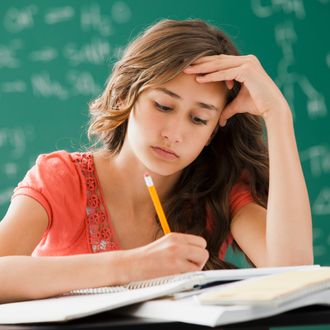 Caucasian teenager studying in classroom