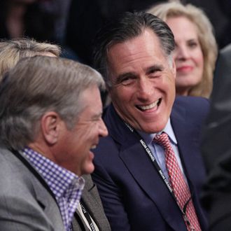 Former Republican presidential candidate Mitt Romney, center, joined by wife Ann, right, talks with an unidentified spectator at ringside prior to a welterweight fight between Juan Manuel Marquez and Manny Pacquiao title fight Saturday, Dec. 8, 2012, in Las Vegas. (AP Photo/Julie Jacobson)