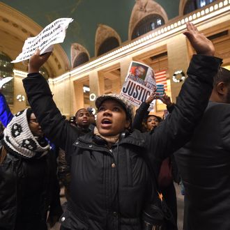 Protestors gather in New York Grand Central Station on December 3, 2014 after a grand jury decided not to charge a white police officer in the choking death of Eric Garner, a black man, days after a similar decision sparked renewed unrest in Missouri. Eric Garner died after being placed in a chokehold by New York police Officer Daniel Pantaleo while being arrested on suspicion of selling untaxed cigarettes in Staten Island. 