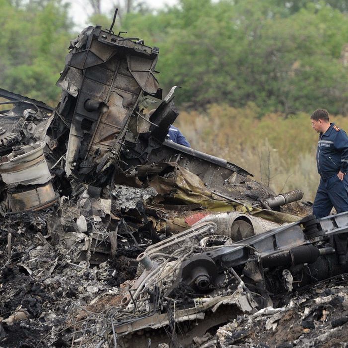 Rescuers stand on July 18, 2014 on the site of the crash of a Malaysian airliner carrying 298 people from Amsterdam to Kuala Lumpur, near the town of Shaktarsk, in rebel-held east Ukraine. Pro-Russian separatists in the region and officials in Kiev blamed each other for the crash, after the plane was apparently hit by a surface-to-air missile. All 298 people on board Flight MH17 died when the plane crashed. Rescue workers at the crash site said that they had found one of the black boxes from the passenger liner. AFP PHOTO/DOMINIQUE FAGET (Photo credit should read DOMINIQUE FAGET/AFP/Getty Images)