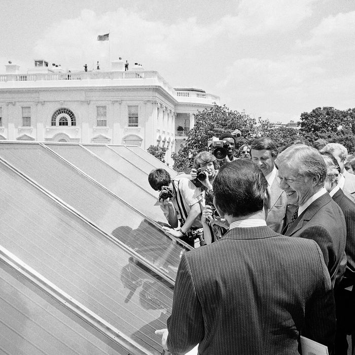 In this June 20, 1979, file photo President Jimmy Carter, center, is surrounded by reporters and photographers as he inspected new White House solar hot water heating system located on the roof of the West Wing of the mansion, over the Cabinet Room. 