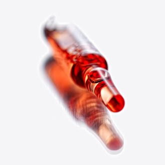 Red vials on white background, close up