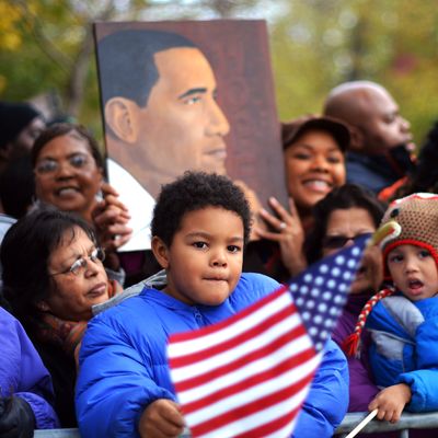 People wait to catch a glimpse of US President Barack Obama's motorcade near his house in Chicago on November 7, 2012. 
