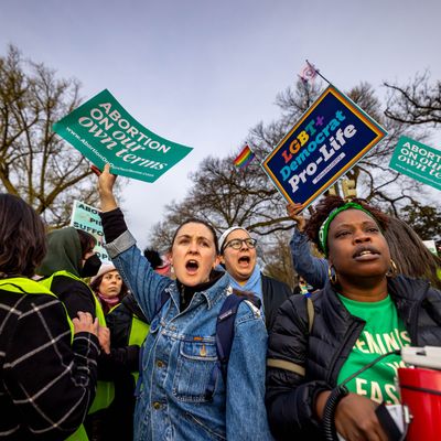 Demonstrators protest and argue outside the U.S. Supreme