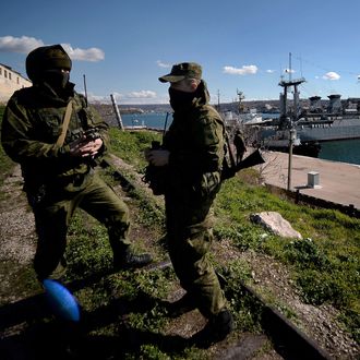 Russian forces patrol near the Ukrainian navy ship Slavutich in the harbor of the Ukrainian city of Sevastopol on March 5, 2014. Russian forces seized partial control of two Ukrainian missile bases in Crimea today as Western and Russian leaders stepped up efforts to defuse the region's worst crisis since the Cold War. 