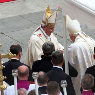 VATICAN CITY, VATICAN - APRIL 27: Pope Francis greets Pope Emeritus Benedict XVI at the end of the Canonization Mass in which John Paul II and John XXIII have been declared Saints on April 27, 2014 in Vatican City, Vatican. Dignitaries, heads of state and Royals from Europe and across the World are to attend the canonisations. (Photo by Franco Origlia/Getty Images)