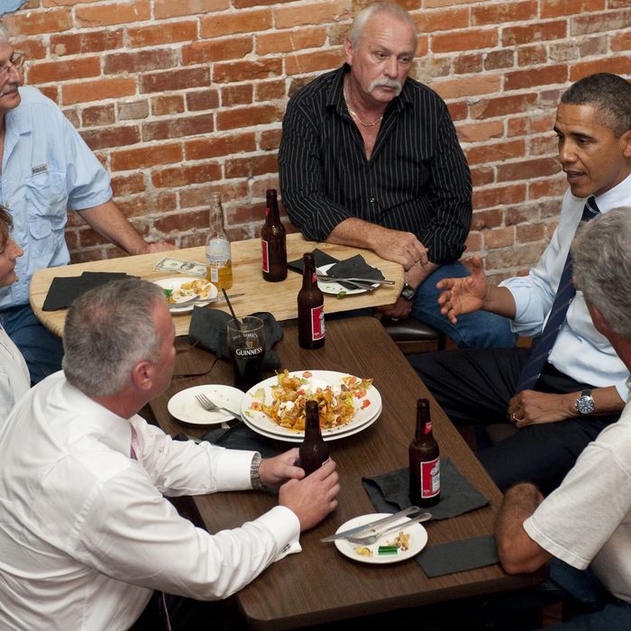 US President Barack Obama (2nd R) talks with unemployed construction workers over beer at the Harp and Celt Restaurant and Irish Pub in Orlando, Florida, October 11, 2011.