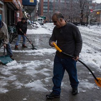 NEW YORK, NY - FEBRUARY 05: Men shovel a snowy sidewalk on February 5, 2014 in the Greenwich Village neighborhood of New York, United States. New York and surrounding regions were hit with yet another snow storm today, bringing snow and ice over night, and sleet and freezing rain during theday. (Photo by Andrew Burton/Getty Images)