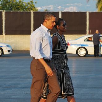 US President Barack Obama and First Lady Michelle Obama make their way to board Air Force One January 2, 2011 at Hickam Air Force Base in Honolulu.